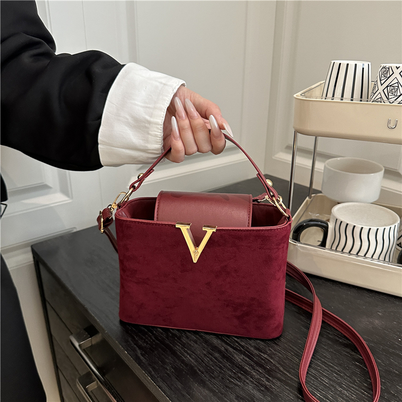 Chic Suede Handbag with V Emblem Elegant and Versatile Top Handle Bag